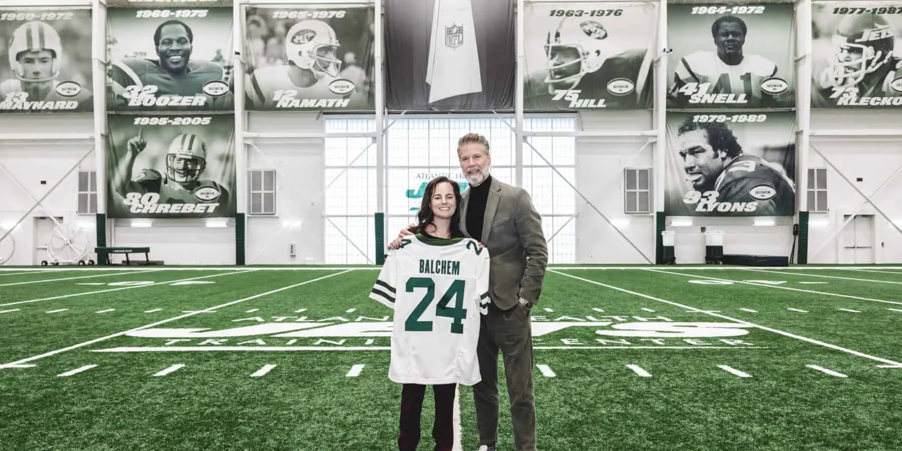 Man and woman with Balchem Jets jersey on field.